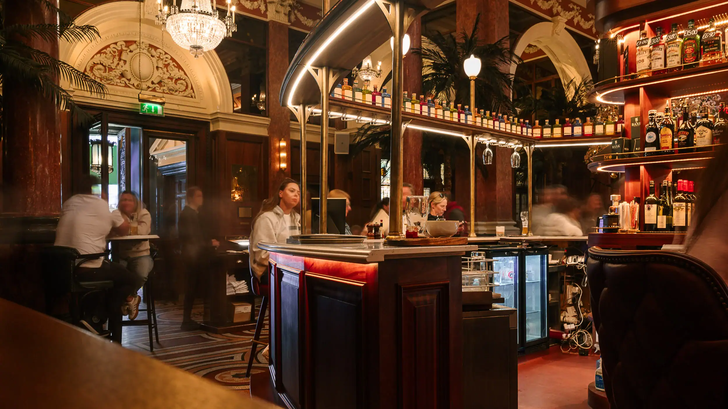 Interior of the Bank on College Green Dublin at night, showing vintage decor, elegant ambiance, and lively crowd enjoying cocktails in a classy nightlife setting.