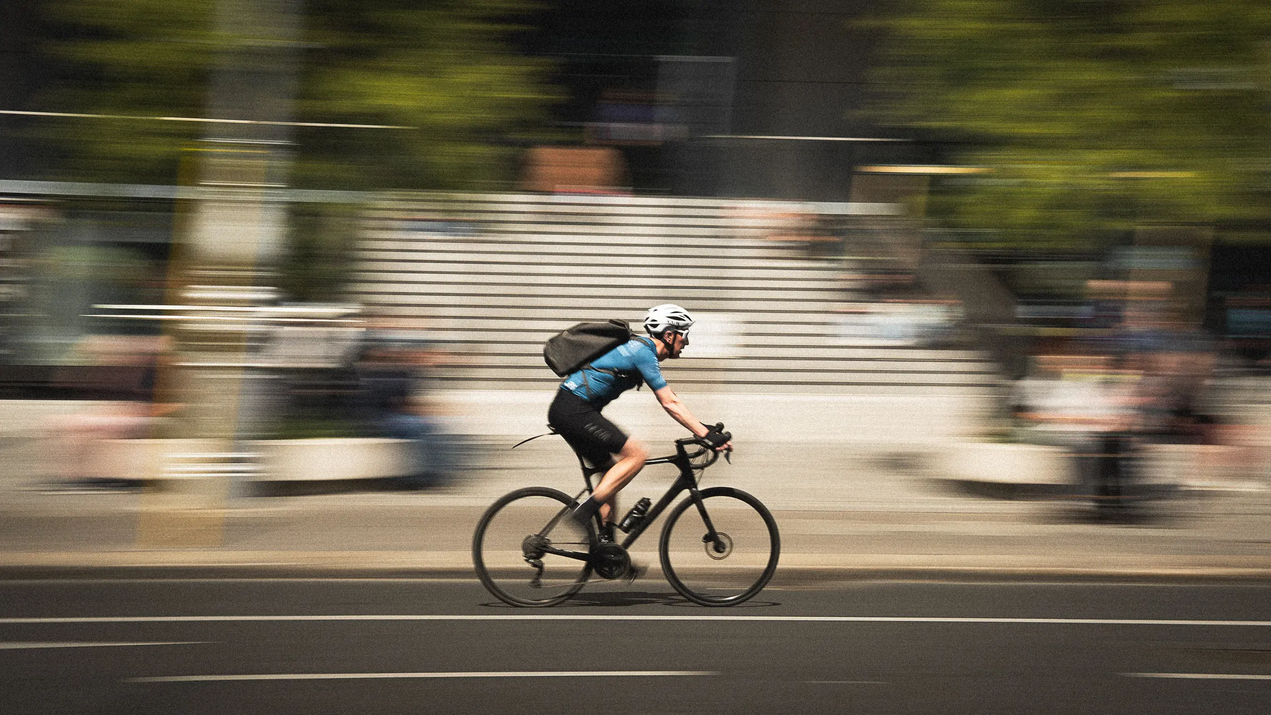 A cyclist speeding through busy Dublin city streets, showcasing the popular and fast-paced bicycle commuting culture with motion blur capturing the rider’s speed.