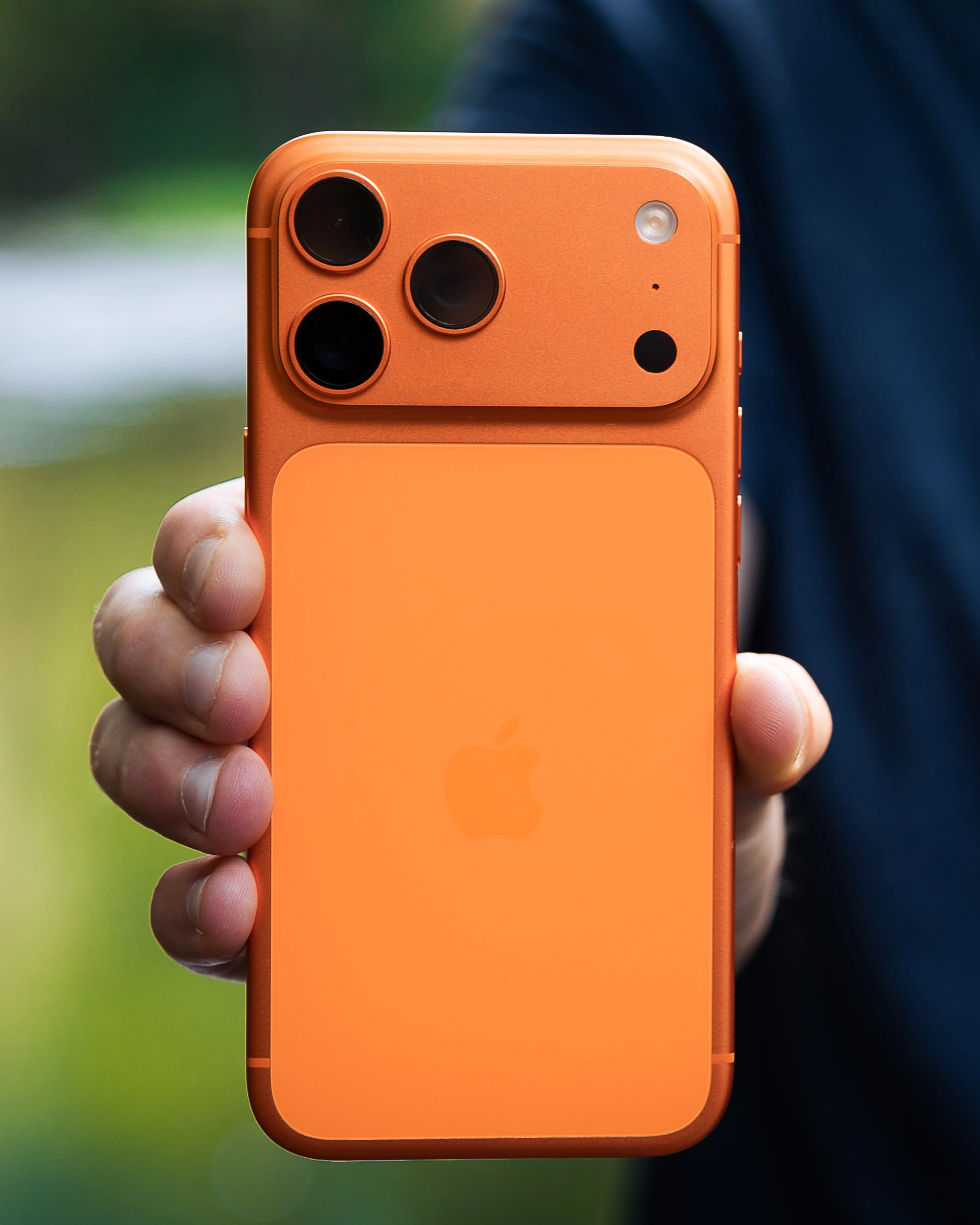 Apple iPhone 17 Pro Max in cosmic orange, highlighting the rear camera and ceramic finish.