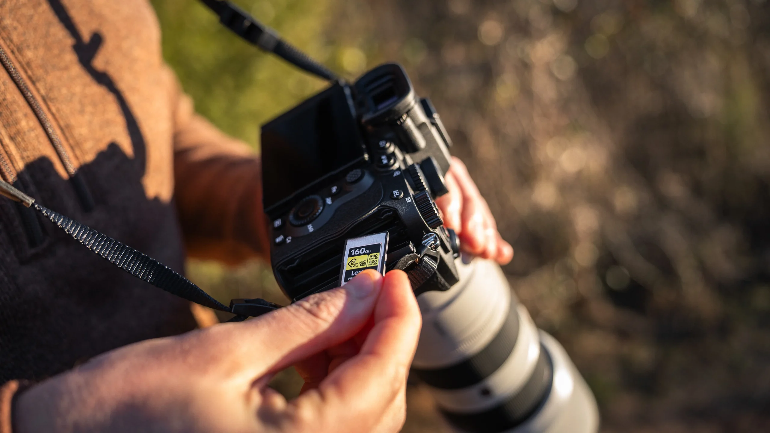 Inserting a Lexar CFexpress Type A memory card into the dual card slots of the Sony A7 V camera